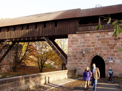 An old timber and stone covered bridge over a river in a public park in Nuernberg, where Rand's great grandparents may have once visited. The muscular angled timbers recall Rand Soellner’s bracing in his work today.