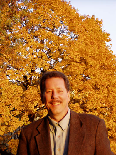 The setting sun bright on a tree behind Rand, just outside of a castle in Nuernberg.