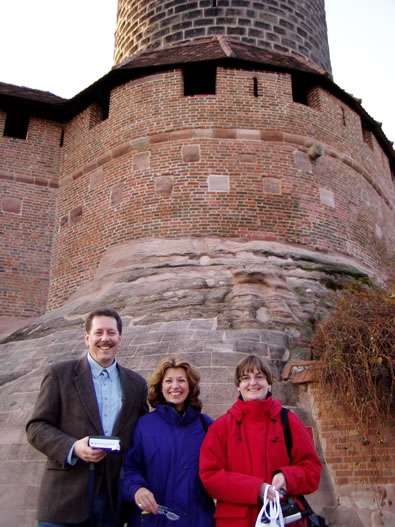 Rand, Merry and German relatives outside of a castle in Nuernberg. The rough stonework is reminiscent of present-day Rand Soellner Architect mountain masonry, where we use boulders in the rock work.