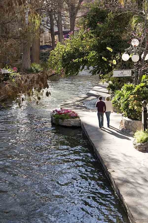 Couples love to stroll along this urban river.