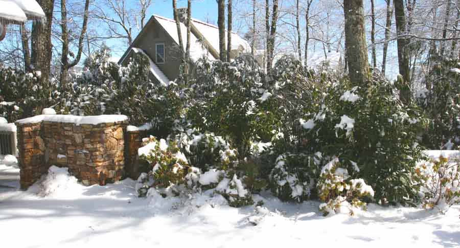 Mountain home designers create landscaping buffers to conceal exterior systems like power generators and gas tanks.  Here is one such treatment by Rand Soellner Architect on one of their projects.  On the left, behind the stone wall is a power generator.  On the right, behind the boxwoods (which stay green in winter) sits the 1,000 gallon LP gas tank.  (C)Copyright 2010 Rand Soellner, All Rights Reserved Worldwide.